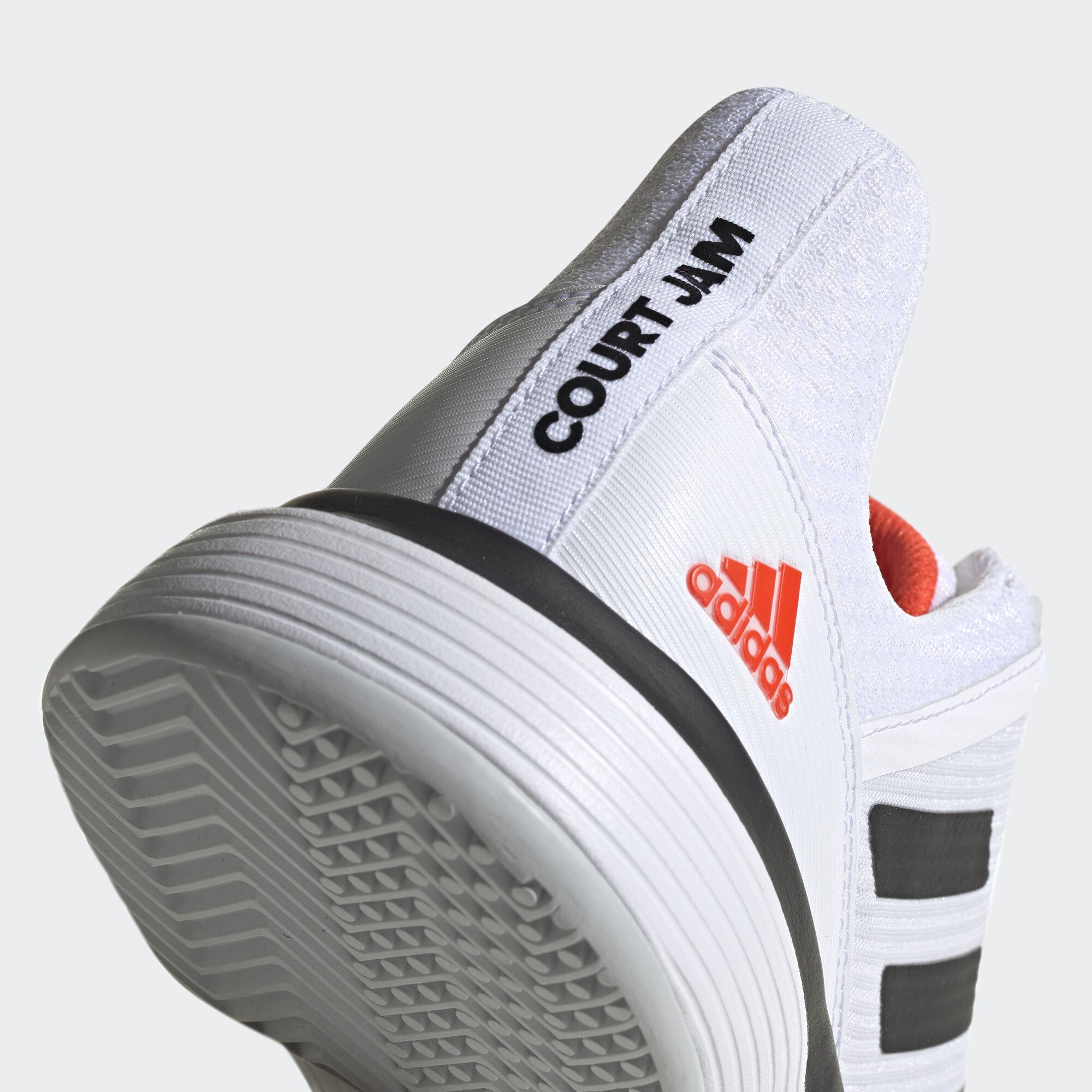 white and orange low top jordans